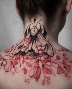 a woman's back neck with flowers and a bee tattoo on her left side