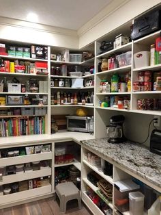 an organized pantry with white shelving and lots of food