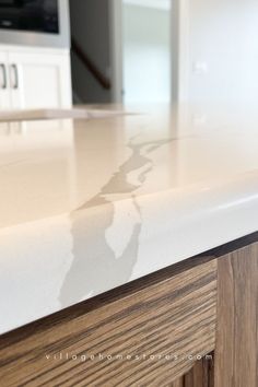 oak cabinet island with white marble look quartz countertop in eased edge profile Quad Cities, Quartz Countertop