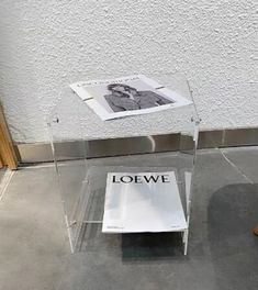 a clear table with a magazine on it