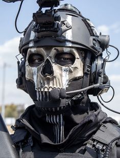 a man wearing a helmet with a skull painted on it's face and holding a camera