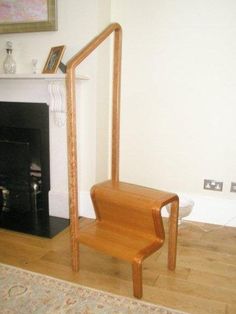 a wooden chair sitting in front of a fire place