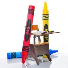 two crayons and a desk with a chair on it