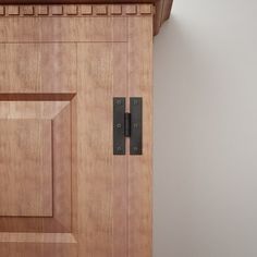 a close up of a wooden door with metal handles