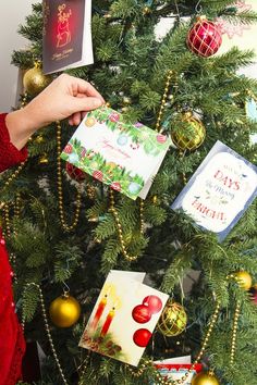 a christmas tree decorated with cards and ornaments