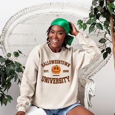 Cute college style halloweentown university halloween sweatshirt. We now use a process to print our shirts that will allow the design to last longer if properly cared for, over 40 washes.In order to provide quick turnaround, we source from four different top clothing brands. If you are needing a specific brand, check with us before ordering for availability.Except for our crop tops, the shirts are UNISEX sizing, it runs larger for women and fit men true to size. Fall Campus T-shirt In College Style, Oversized Varsity T-shirt For Fall, College Style T-shirt For Game Day In Fall, College Fall Fan Apparel T-shirt, Collegiate Fall Campus Sweatshirt, Fall School Spirit Sweatshirt With Relaxed Fit, Fall School Spirit Relaxed Fit Sweatshirt, College Fan Apparel T-shirt For Fall, Fall Collegiate Graphic Print Sweatshirt