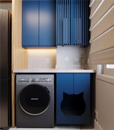 a washer and dryer in a room with blue cupboards on the wall