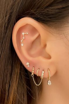 a woman's ear with three different types of piercings on the side of her ear