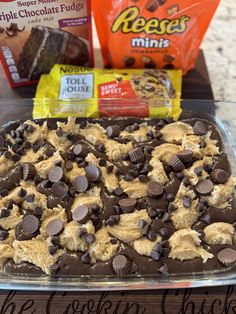 a pan filled with cookies and chocolate chips next to bags of reese's minis