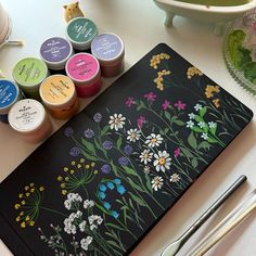 an assortment of crafting supplies sitting on top of a table