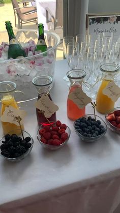 the table is set up with different types of fruit and drinks for guests to enjoy