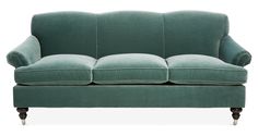 a green couch with wooden legs on a white background