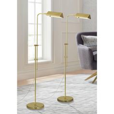 two floor lamps in the middle of a living room