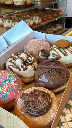 a box filled with lots of different flavored donuts