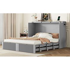 a bed with drawers underneath it in a room