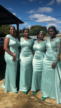 the bridesmaids are posing for a photo in their mint green gowns and matching shoes