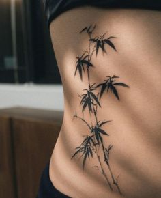 a woman's back with bamboo leaves on it