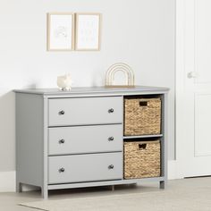 a gray dresser with two baskets on top