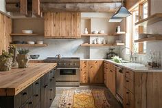 a kitchen with wooden cabinets and an area rug