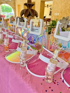 there are many bottles on the table with confetti around them and some decorations