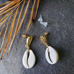 "Stud earrings so chic and easy to wear. Quality gold plated brass cowries wire wrapped to a natural white cowry shell. Hangs 1.5\" total." Cowry Shell, Cowrie Shell, Wire Wrapped, Wire Wrapping, Hippie Boho, Etsy Earrings, Dangle Drop Earrings, Pearl Earrings, Shells