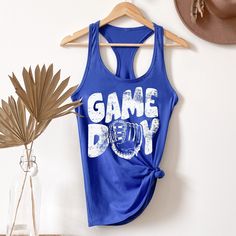 This game day baseball tank is perfect for the hot spring and summer games. Game Day! This soft distressed baseball tank is one of the most comfortable shirts out there and the slim fit makes it perfect for watching all the games!  ** P R O D U C T ** .: 60% combed ring-spun cotton, 40% polyester .: Extra Light fabric  .: Tear-away label .: Slim Fit ** S I Z I N G **  - Consult size chart in listings for measurements  ** S H I P P I N G ** - Allow 1-3 business days for production. - Free standar Summer Crew Neck Tank Top For Sports Events, Casual Letter Print Tank Top For Sports Events, Cotton Tank Top For Sports Season, Summer Sports Fan Tops In Team Colors, Graphic Print Tank Top For Summer Sports Events, Sleeveless Tops For Sports Events With Team Spirit, Casual Muscle Tank Tee For Sports Events, Sports Fan Tops For Game Day In Summer, Cotton Tank Top With Letter Print For Sports Events