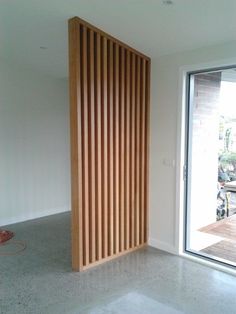 an empty room with wooden slats on the wall