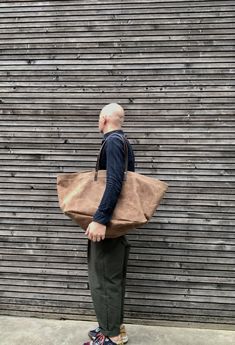 This XXL tote bag is made from American heavy weight waxed canvas,(18oz) The color is tan. The design was inspired on the blue IKEA shopping bag, I used around the same size Perfect for a trip to the market, work, or even big enough for weekend away, . All the bags are made and designed by myself and handmade with care one at a time and attention for details. The carry all measures approximately 54 cm wide, 43 cm tall and 35 cm deep, at the bottom. In inches this is 21,2 inches wide, 16,9 inches Wax Canvas Bag, Casual Brown Waxed Canvas Bag, Casual Brown Cotton Weekender Bag, Brown Cotton Weekender Bag For Everyday Use, Brown Duck Canvas Bag, Brown Canvas Weekender Bag With Waxed Finish, Brown Cotton Canvas Bag With Leather Handles, Brown Cotton Weekender Bag With Leather Handles, Brown Duck Canvas Tote Bag