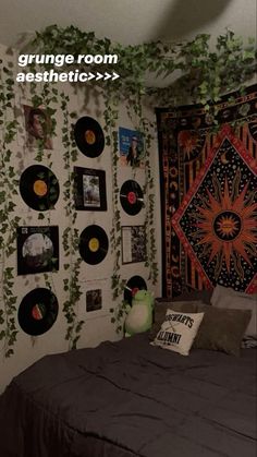 a bed room with a neatly made bed and lots of records on the wall