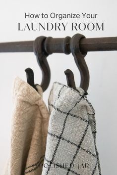 two towels hanging on a rail with the title how to organize your laundry room