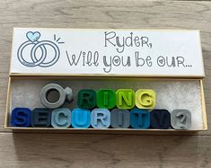 the word ring security spelled out in colorful letters on a wooden table with a sign