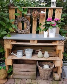 a potting bench made out of wooden pallets with plants and buckets on top