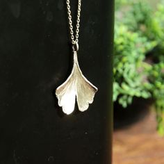 Ginkgo leaf pendant with sterling silver chain. Your personal longevity amulet. This natural ginkgo pendant was created on the basis of a real ginko biloba leaf. It is made of a good quality brass covered with pure silver. The pendant is 3,3 cm (1.3 inches) long. The set includes a 925 silver chain. You can choose the length of the chain. Available lengths: S: 40 cm - 15.75 inches  M: 50 cm - 19.69 inches L: 70 cm - 27.56 inches Each of them has a 5 cm (1.97 inches) extension.  Matching earrings available here: https://www.etsy.com/listing/1501143922/ginkgo-leaf-dangle-earrings-in-silver A true masterpiece of nature-inspired jewelry. Handcrafted with precision and inspired by the beauty of plants, this necklace showcase the intricate details of a real oak leaf, capturing its organic charm. Delicate Silver Brass Necklaces, Delicate Silver Brass Necklace, Nature-inspired Silver Brass Necklaces, Nature-inspired Silver Brass Necklace, Silver Leaf-shaped Necklace Gift, Silver Leaf-shaped Necklaces For Gift, Silver Leaf-shaped Necklace For Gift, Sterling Silver Leaf-shaped Jewelry Gift, Sterling Silver Leaf-shaped Jewelry In Yellow Gold