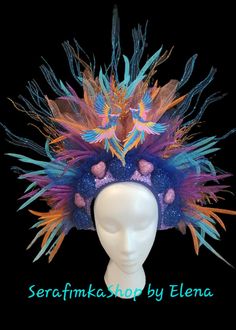 Beautiful Phoenix Fire Mardi Gras headdress could be a great addition to your fun party outfit... Decorated with sparkly blue, orange twigs, sparkly blue balls, pink hearts, colorful mesh, tulle, sequin, ..in the middle two Azure blue, Pink, Gold embroidered Phoenix birds. Blue back side.  Light weight, elastic in the back, fits most heads. Colors might look sliightly different from pictures due to your screen setting. All crowns hand made. Shipped by USPS next business day! NO refunds, NO returns, but please let me know if something wrong with your item.  Check my shop for other Holiday crowns and matching face mask. Contact me for special orders. Thank you for your interest in my design. Have fun, stay safe. Carnival Costume Party Hat With Structured Crown, Costume Hats With Structured Crown For Carnival, Structured Crown Costume Hats And Headpieces For Carnival, Fantasy Style High Crown For Parties, Whimsical Costume Hat With Tall Crown For Costume Party, Round Crown Headpiece For Carnival Costume Party, Whimsical Tall Crown Costume Hat For Costume Party, Whimsical Headpieces For Carnival And Halloween, Carnival Costume Party Headpiece With Round Crown