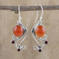 These vibrant sterling silver dangle earrings boast a mesmerizing combination of carnelian and garnet gemstones with delightful swirl motifs that imbue them with a sense of graceful movement. Make a statement with these stunning earrings presented by India's Shanker that effortlessly fuse classic elegance with modern flair. Elegant Silver Carnelian Earrings, Silver Carnelian Earrings, Graceful Movement, Woo Woo, Diy Wire Jewelry, Tiny Earrings, Silver Dangle Earrings, Garnet Earrings, Sterling Silver Dangle Earrings