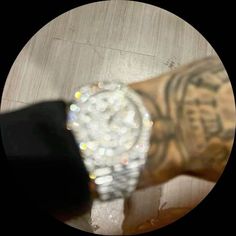 a close up of a person's wrist with a diamond watch on the wrist