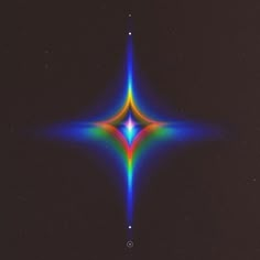 an image of a multicolored star in the dark