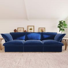 a blue couch sitting on top of a rug in a living room next to a table