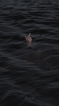 a hand sticking out of the water with it's fingers up in the air