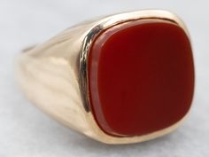 "Substantial and striking, this could be a great piece for a man or a woman! The style has clean lines that keep the ring simple! The center is a smooth and warm Carnelian, which has a lovely orange-red hue! Metal: 10K Yellow Gold Gem: Carnelian  Gem Measurements: 14.6 mm, Square Cushion Cut Ring Size: 8.75 Marks: \"10K W\" Stamped on the inside band To view a video of this piece check out the link below: https://vimeo.com/818890333 SKU #: A25241 Each piece has been identified and graded by a Gr Modern Red Rings For Formal Occasions, Modern Red Ring For Formal Occasions, Classic Carnelian Signet Ring With Polished Finish, Classic Carnelian Signet Ring For Formal Occasions, Classic Carnelian Signet Ring For Formal Events, Red Carnelian Ring With Polished Finish, Classic Red Signet Ring For Formal Occasions, Red Carnelian Rings With Polished Finish, Red Polished Carnelian Rings