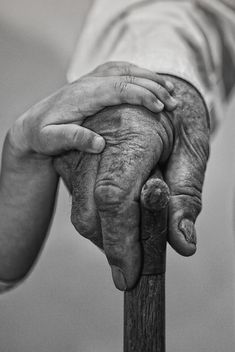 black and white photograph of an old person holding a cane