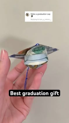 a person holding a money origami bird with the words best graduation gift on it