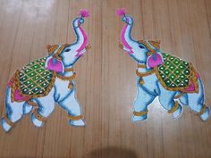 two elephants painted on wooden floors with one elephant holding the other's trunk up