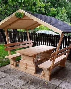 a wooden picnic table with two benches underneath it