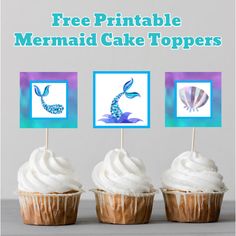 three cupcakes with white frosting and seahorse toppers