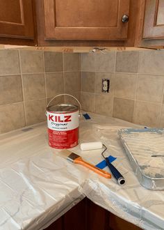 a bucket of paint sitting on top of a counter