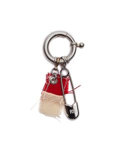 a keychain with a red and white piece of cloth hanging from it's side