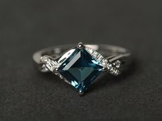 Welcome to my shop, you can find many beautiful gemstone jewelry here, and you also can ask for customized service. Main Stone: London blue topaz, square cut 7X7mm, about 2.30 carats Accent Stones: cz Metal: 925 sterling silver plated with rhodium. I also can provide metal options such as 14k solid yellow/white/rose gold Setting: prong setting More rings: https://www.etsy.com/shop/XCjewelryStudio?ref=hdr_shop_menu It's a perfect gift for the person who was born in November (Birthstone), it's qui Wedding Square Cut Topaz Ring, Square Cut Topaz Wedding Ring, Elegant Square Cut Topaz Promise Ring, Square Cut Topaz Ring For Wedding, Blue Square Cut Topaz Ring, Blue Topaz Ring With Square Cut, Elegant Blue Topaz Princess Cut Jewelry, Elegant Princess Cut Blue Topaz Ring, Elegant Square Cut Topaz Ring Gift