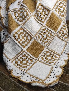 a crocheted blanket sitting on top of a chair