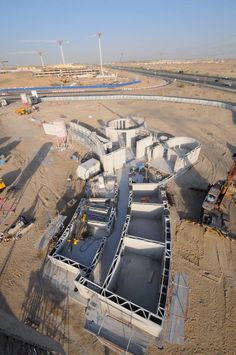 an aerial view of the construction site for a new building under construction in qatar, with cranes and other equipment